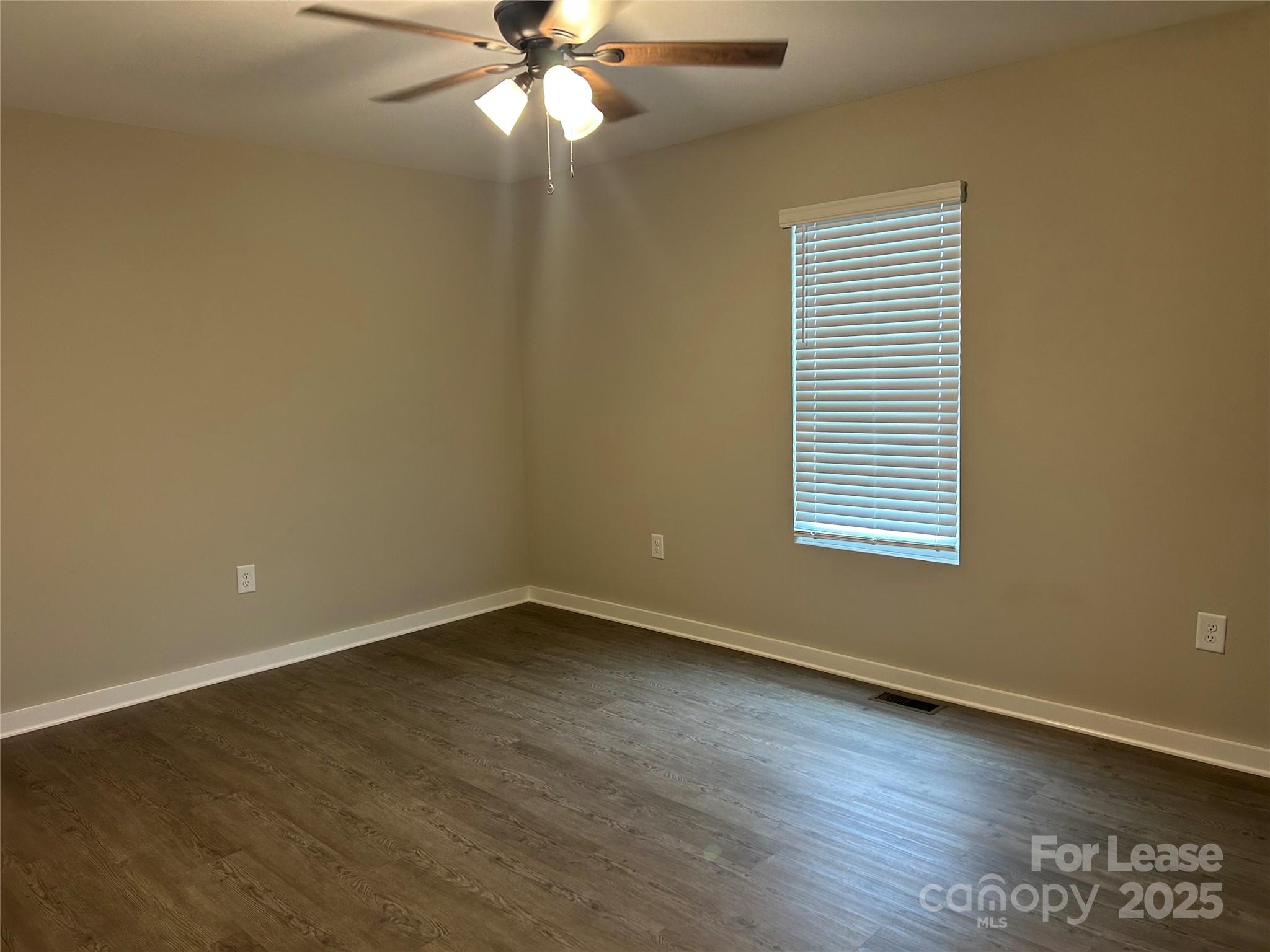 3297 Paul Elmore Road Lincolnton, NC 28092 - Photo 10 of 14 an empty room with wooden floor and windows