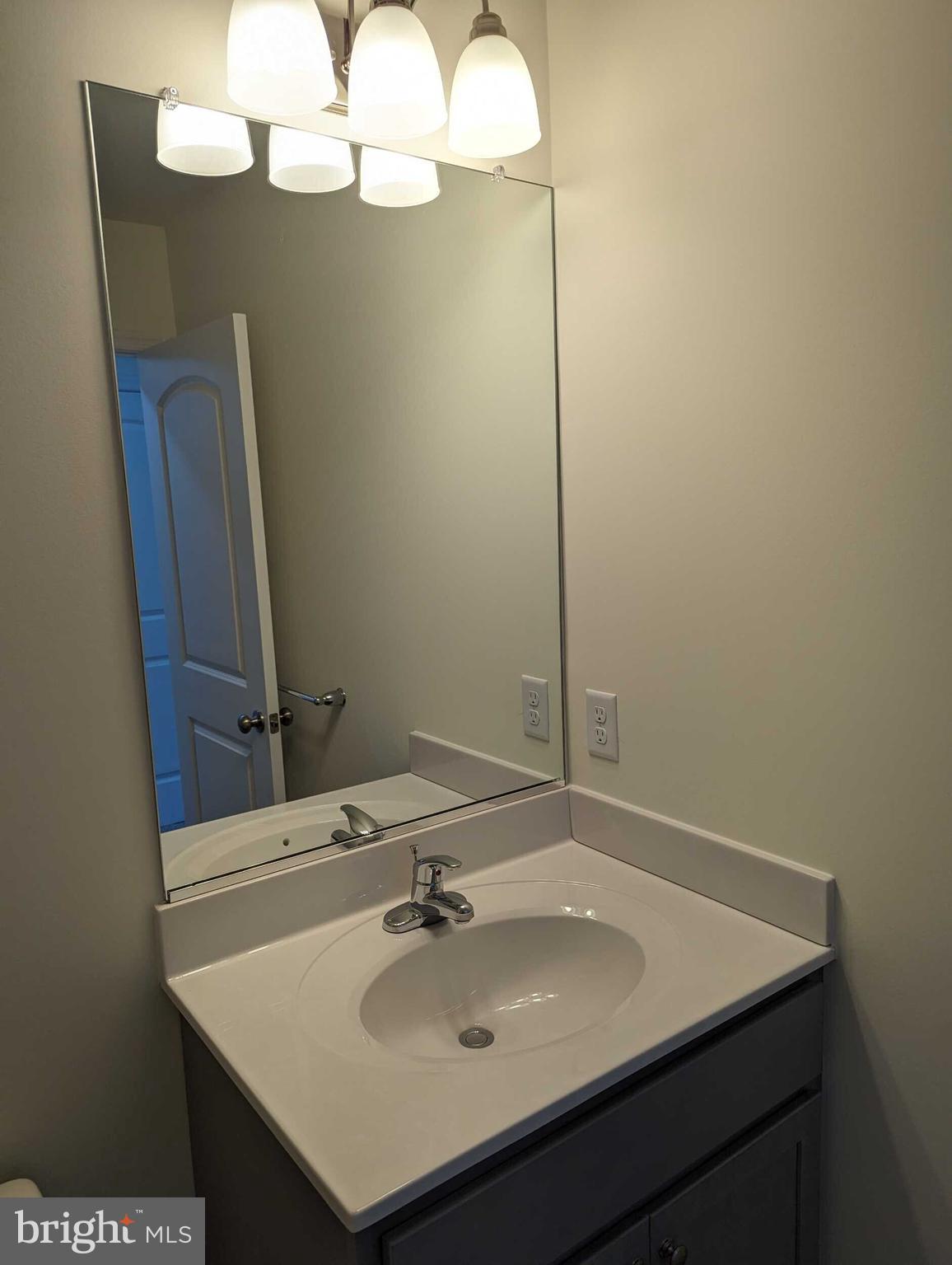 227 Rojan Road Dover, DE 19901 - Photo 8 of 20 a bathroom with a sink and a mirror