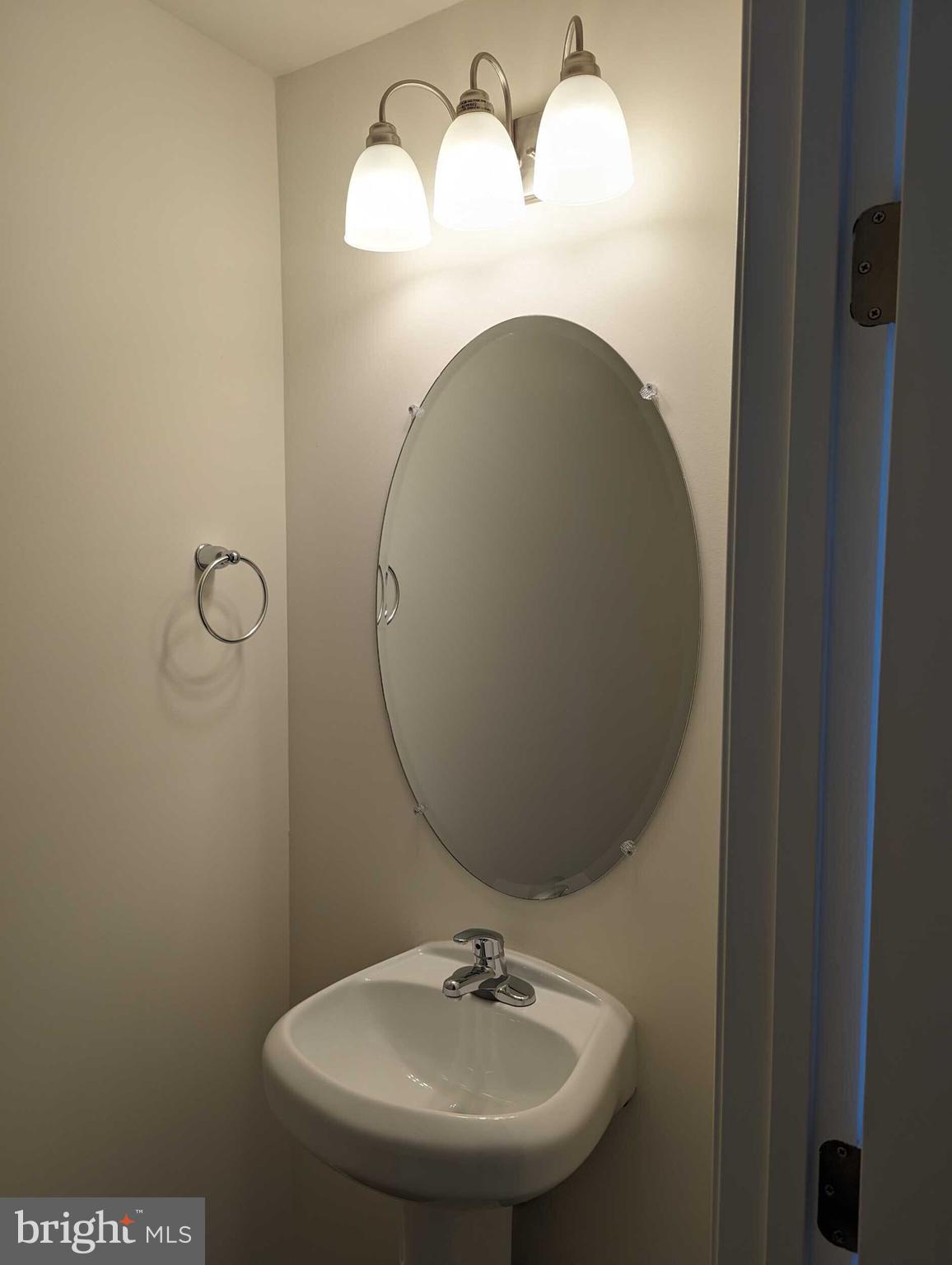 227 Rojan Road Dover, DE 19901 - Photo 9 of 20 a bathroom with a sink and a mirror