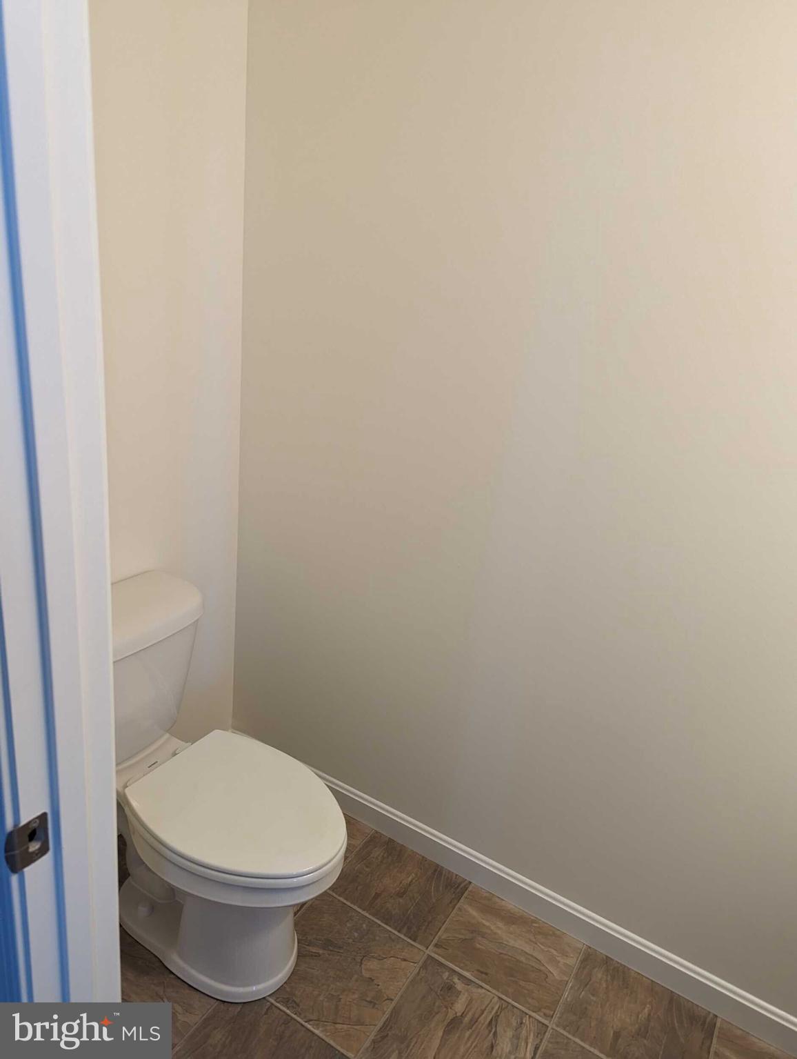 227 Rojan Road Dover, DE 19901 - Photo 10 of 20 a white toilet sitting next to a shower