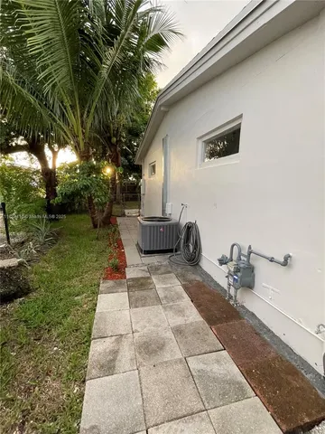 a backyard of a house with outdoor seating