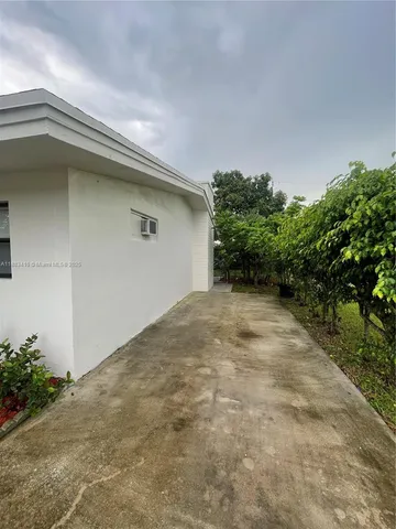 a backyard of a house with plants and trees