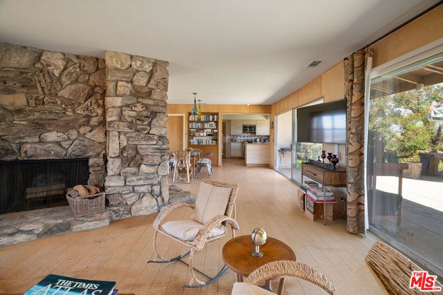 a living room with furniture a rug and a fireplace