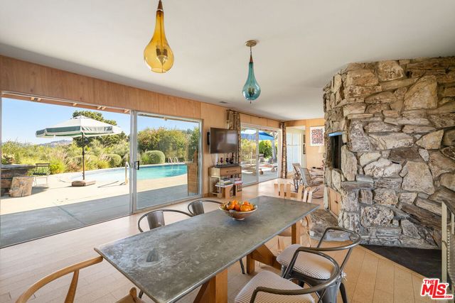 a view of a dining room with furniture wooden floor and a chandelier