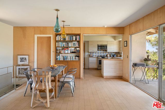 a dining room with furniture and a floor to ceiling window