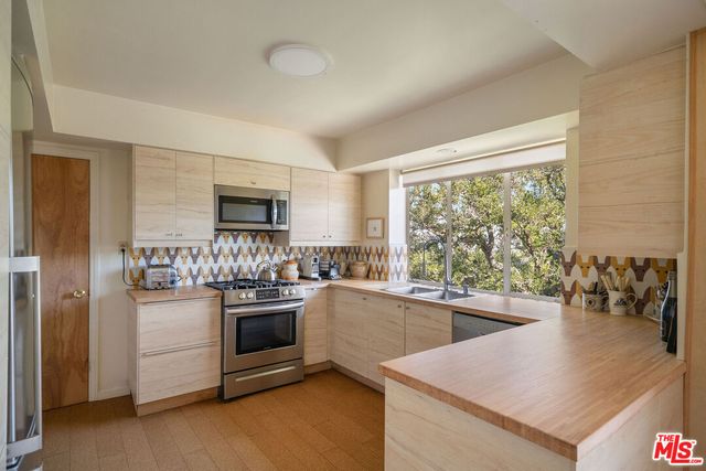 a kitchen with stainless steel appliances granite countertop a stove and a sink