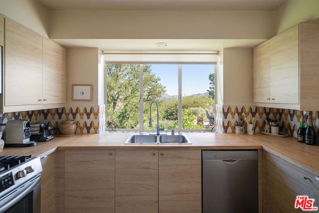 a bathroom with a double vanity sink and a large mirror