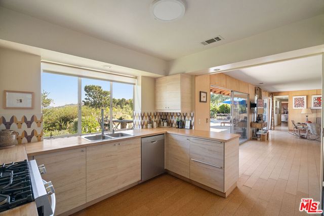 a kitchen with sink refrigerator and cabinets