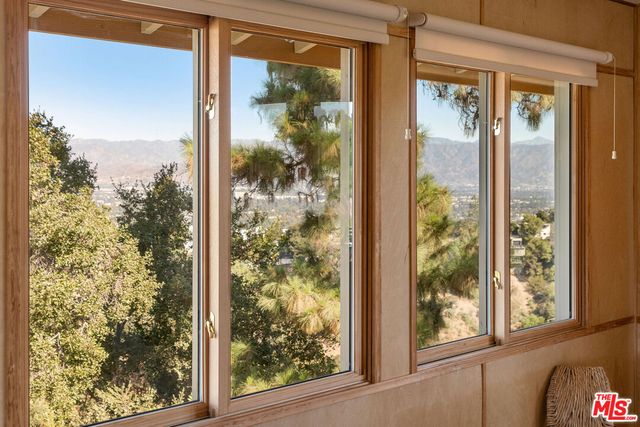 a view of a room with a large window and front door