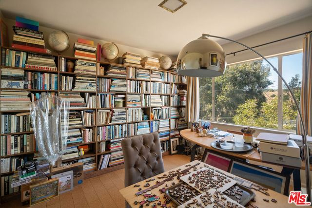 a reading room with lots of furniture and a book shelf