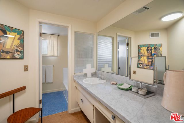 a spacious bathroom with sinks and a mirror