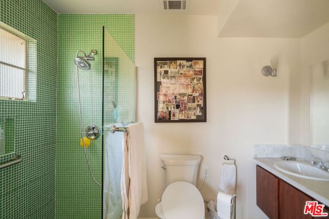 a bathroom with a toilet a sink and shower