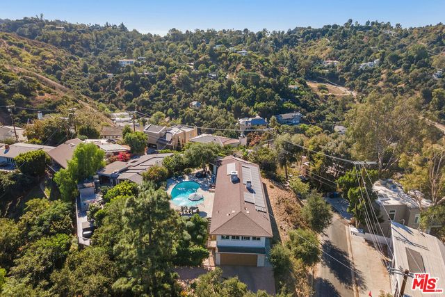 an aerial view of a house with a yard