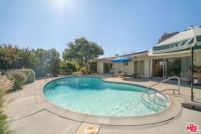 a view of a swimming pool with a patio