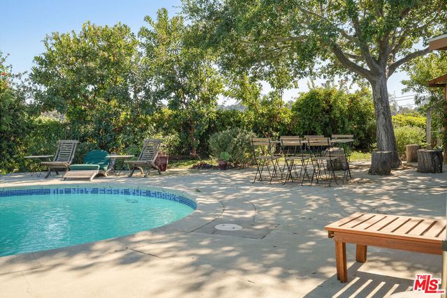 a view of a swimming pool with a patio
