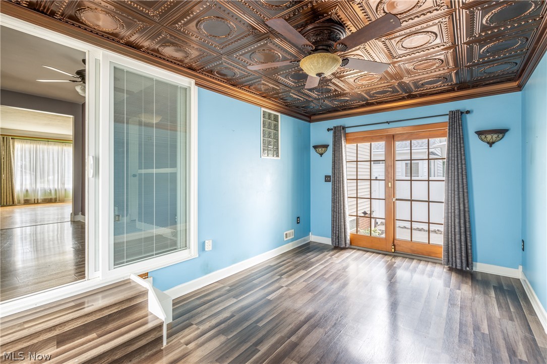 29220 Ridge Road Wickliffe, OH 44092 - Photo 17 of 34 Spare room featuring ceiling fan, french doors, and dark wood-type flooring