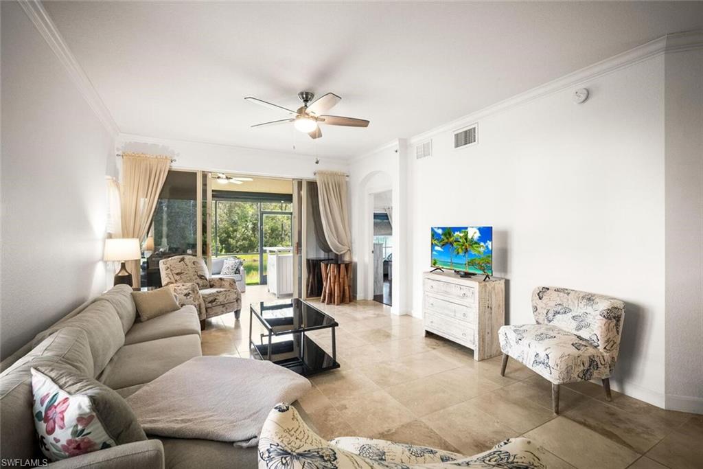 8701 Piazza Del Lago Circle, Unit 101 Estero, FL 33928 - Photo 14 of 50 a living room with furniture and a flat screen tv