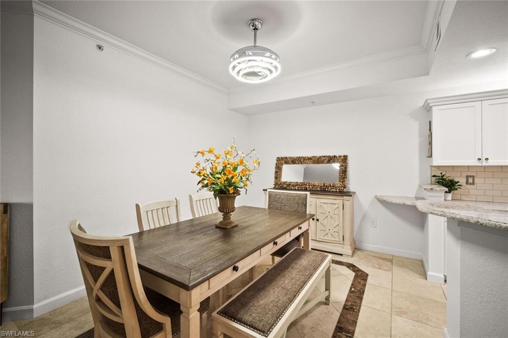8701 Piazza Del Lago Circle, Unit 101 Estero, FL 33928 - Photo 16 of 50 a dining room with furniture and window