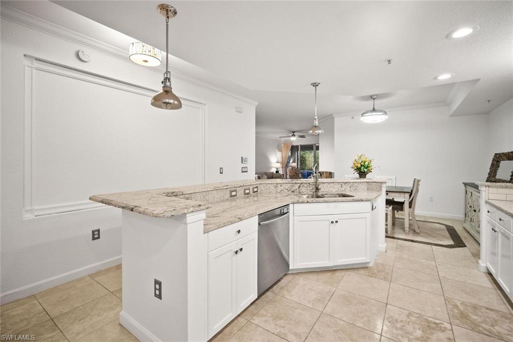 8701 Piazza Del Lago Circle, Unit 101 Estero, FL 33928 - Photo 23 of 50 a kitchen with a white cabinets and chandelier