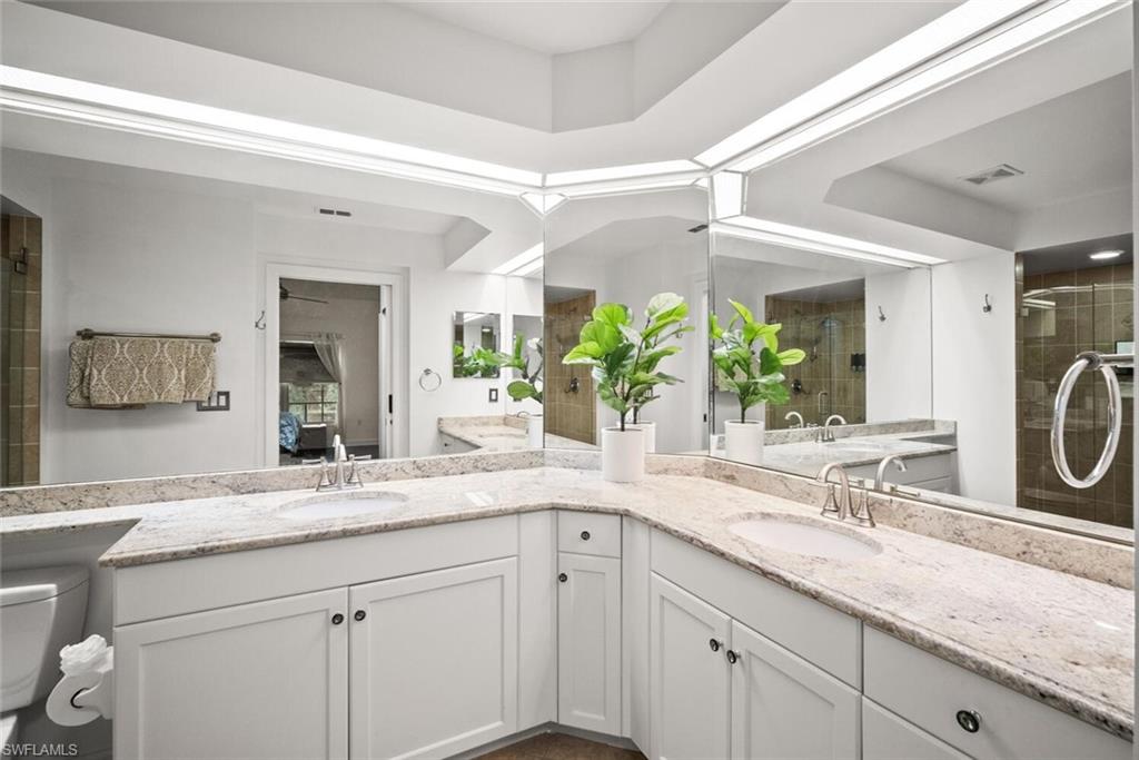 8701 Piazza Del Lago Circle, Unit 101 Estero, FL 33928 - Photo 29 of 50 a bathroom with a sink and a mirror
