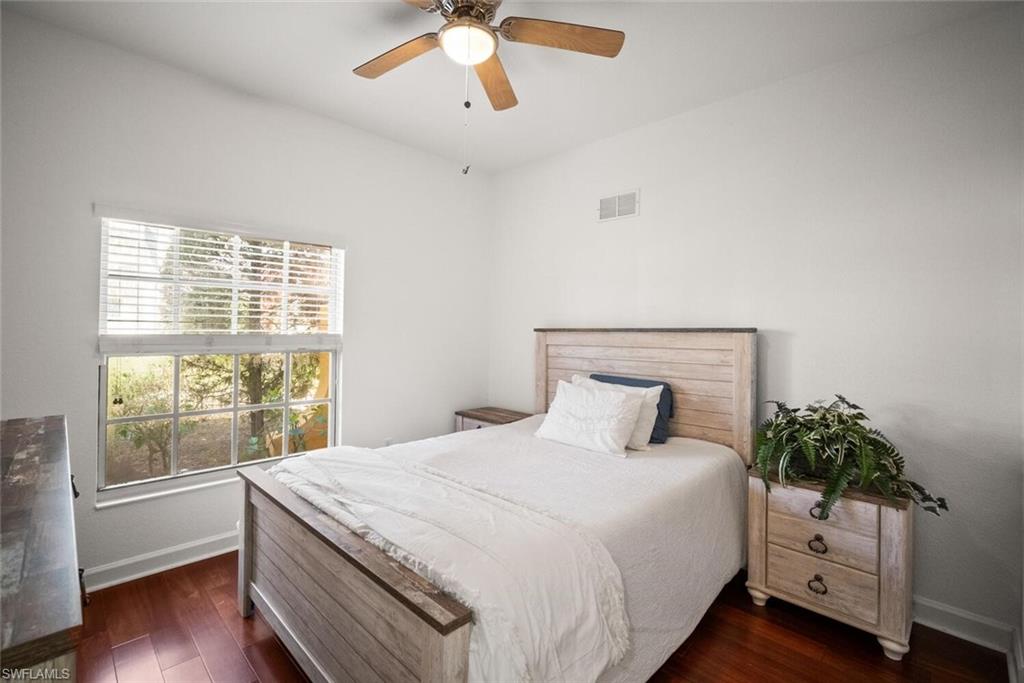 8701 Piazza Del Lago Circle, Unit 101 Estero, FL 33928 - Photo 31 of 50 a bedroom with a large bed and a potted plant