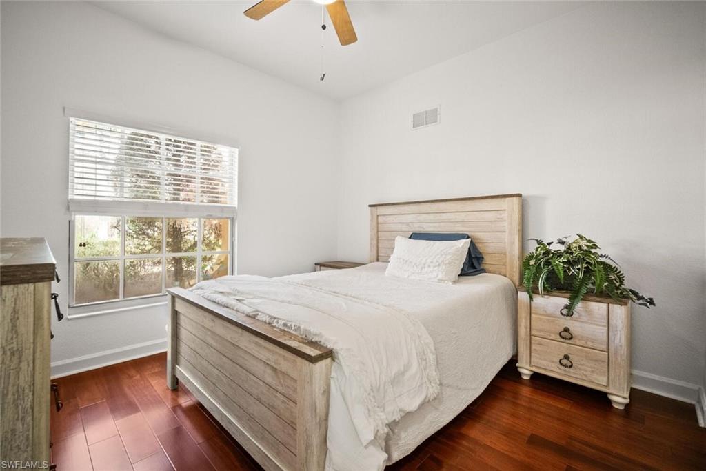 8701 Piazza Del Lago Circle, Unit 101 Estero, FL 33928 - Photo 33 of 50 a bedroom with a bed and a large window