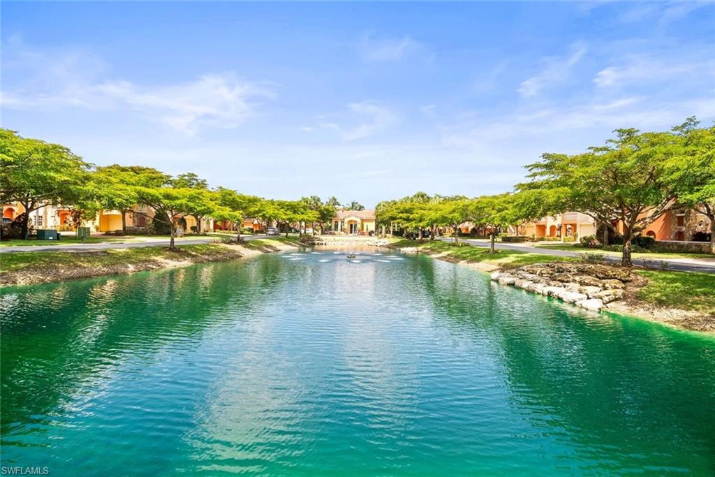 8701 Piazza Del Lago Circle, Unit 101 Estero, FL 33928 - Photo 39 of 50 a view of a lake with houses in the back