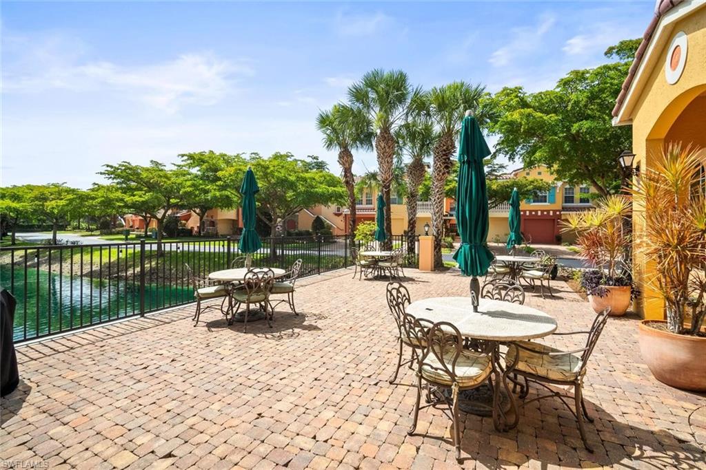 8701 Piazza Del Lago Circle, Unit 101 Estero, FL 33928 - Photo 42 of 50 a view of a lake with a table and chairs
