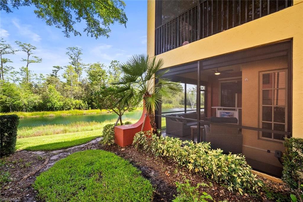 8701 Piazza Del Lago Circle, Unit 101 Estero, FL 33928 - Photo 6 of 50 a view of a backyard with couches chair under an umbrella