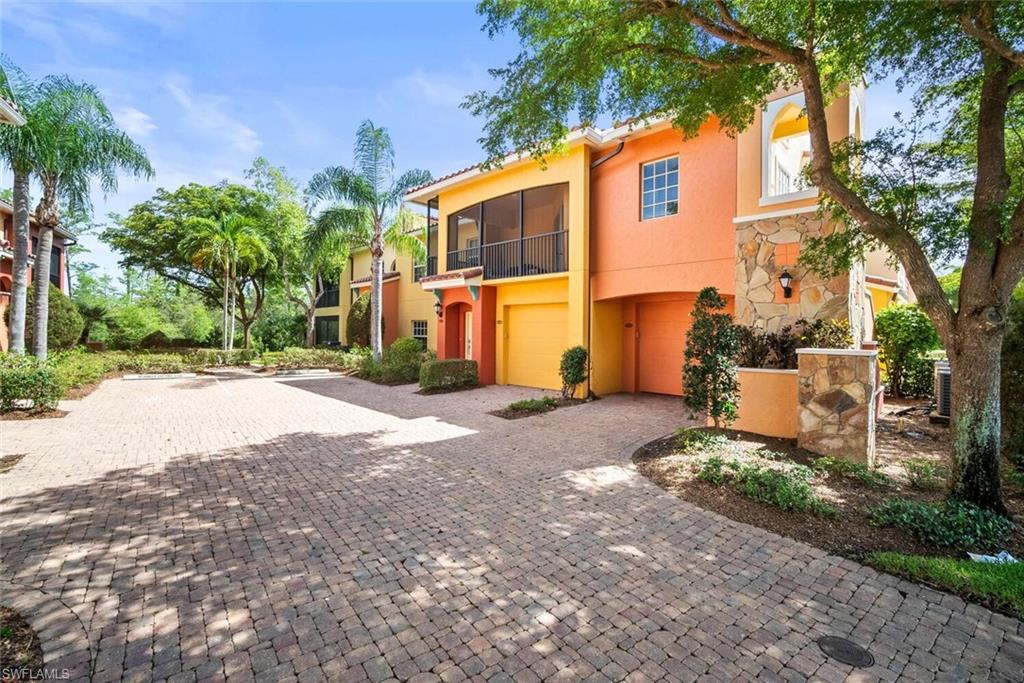 8701 Piazza Del Lago Circle, Unit 101 Estero, FL 33928 - Photo 9 of 50 a front view of a house with a yard and tree s