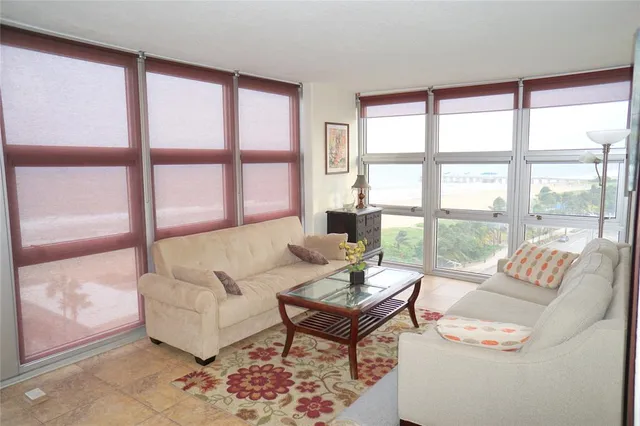 a bedroom with a bed and flat tv screen on the dresser