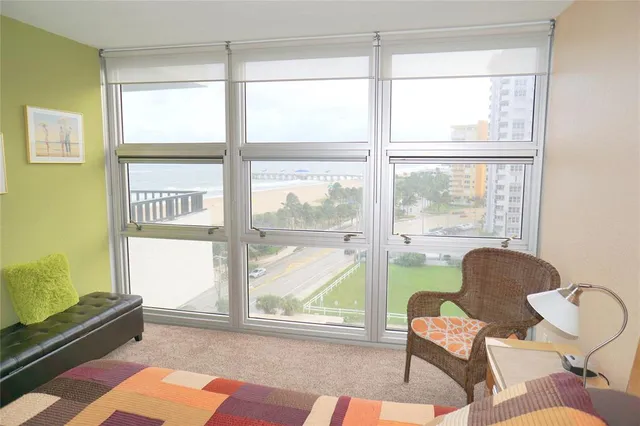 a spacious bedroom with two beds and chair