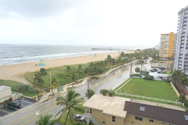 a bathroom with a granite countertop toilet and a sink