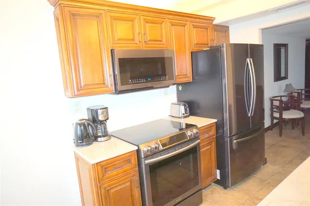a living room with furniture a flat screen tv and a large window