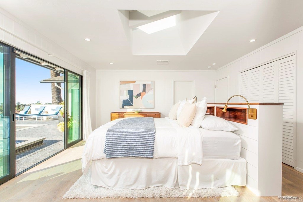 1237 Muirlands Vista Way La Jolla, CA 92037 - Photo 15 of 25 a bedroom with a large bed and a large window
