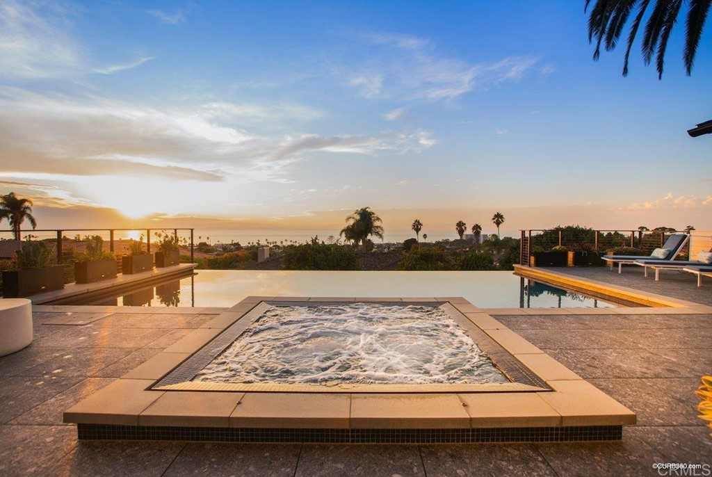 1237 Muirlands Vista Way La Jolla, CA 92037 - Photo 19 of 25 a view of a swimming pool with a lounge chair