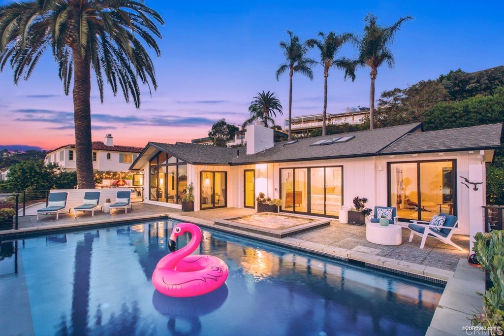 1237 Muirlands Vista Way La Jolla, CA 92037 - Photo 3 of 25 a view of a swimming pool with a table and chairs