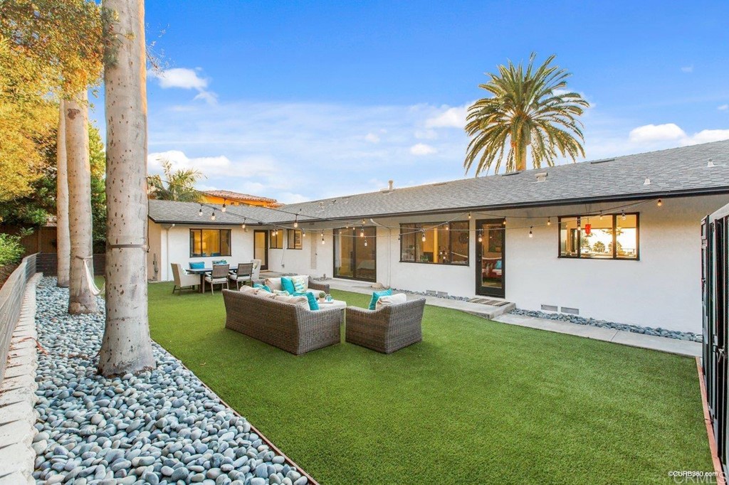 1237 Muirlands Vista Way La Jolla, CA 92037 - Photo 23 of 25 a view of a house with backyard sitting area and garden