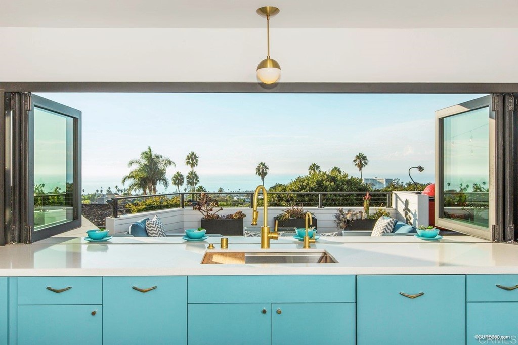 1237 Muirlands Vista Way La Jolla, CA 92037 - Photo 6 of 25 a kitchen with a sink and a wooden floor