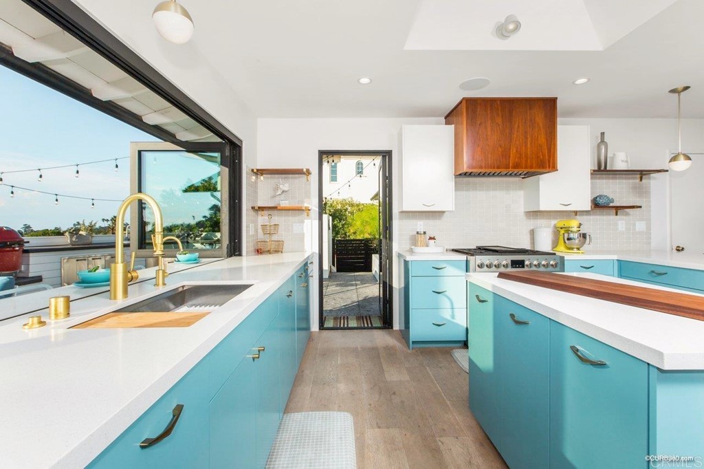 1237 Muirlands Vista Way La Jolla, CA 92037 - Photo 8 of 25 a kitchen with a sink a stove and cabinets