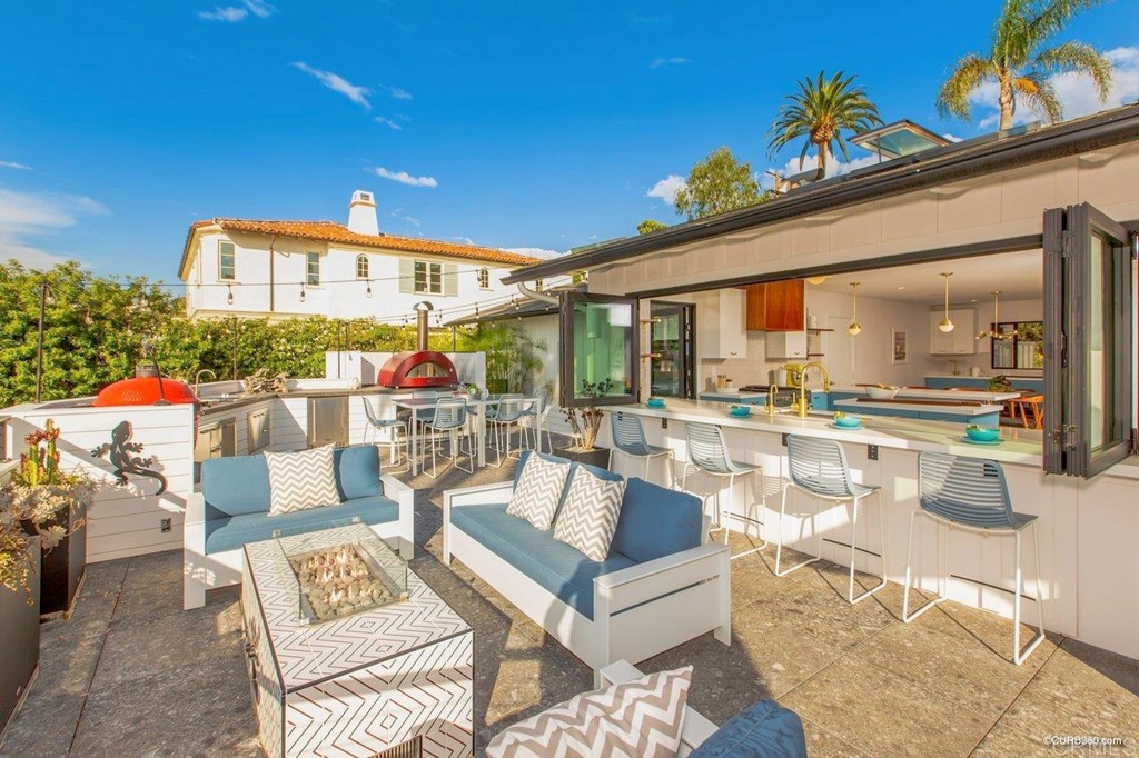 1237 Muirlands Vista Way La Jolla, CA 92037 - Photo 10 of 25 a living room with patio furniture and a potted plant