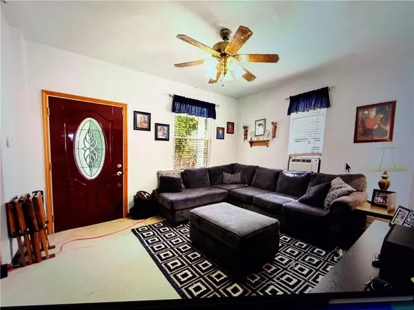 a living room with furniture a clock and a window