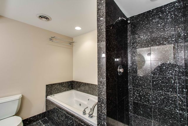a bathroom with a bathtub and shower