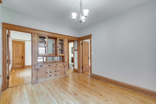 an empty room with wooden floor and a window