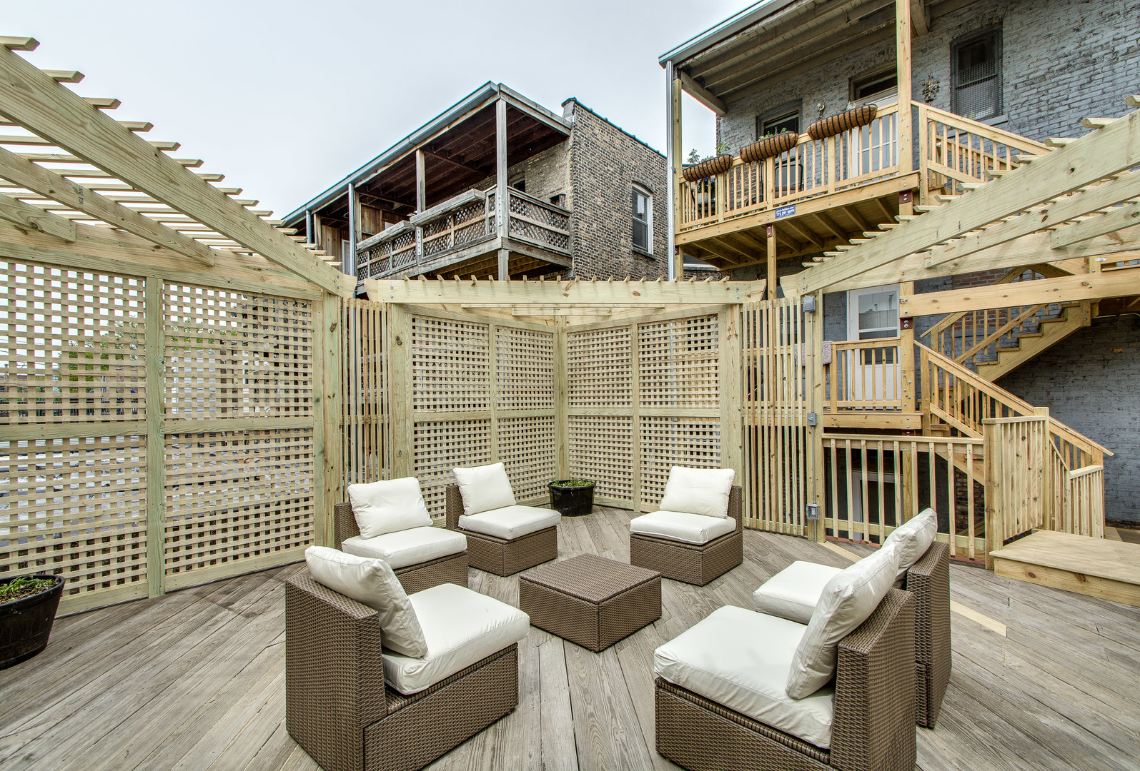 2905 West Logan Boulevard Chicago, IL 60647 - Photo 35 of 36 a view of a patio with couches table and chairs with wooden floor