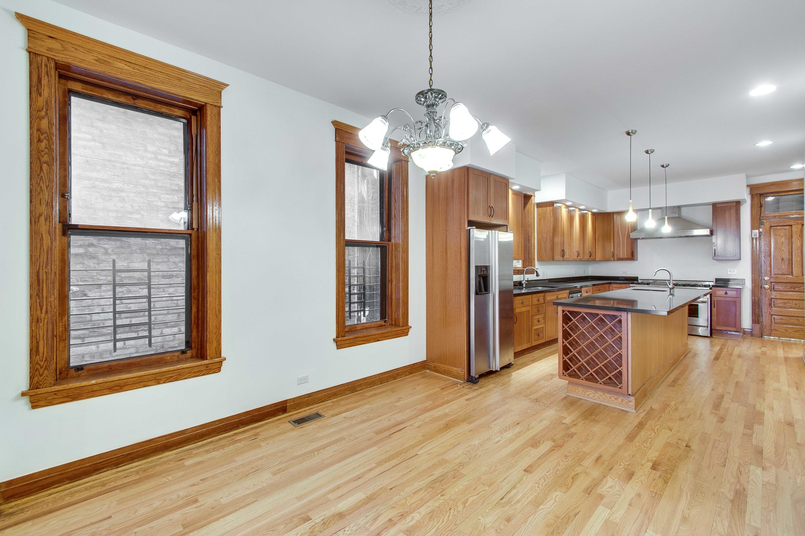 2905 West Logan Boulevard Chicago, IL 60647 - Photo 8 of 36 a kitchen with stainless steel appliances granite countertop a refrigerator a oven a sink and a wooden floors