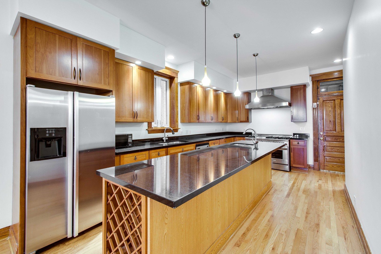 2905 West Logan Boulevard Chicago, IL 60647 - Photo 9 of 36 a kitchen with stainless steel appliances granite countertop a sink a refrigerator and a stove
