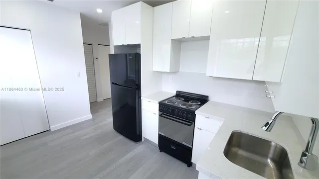 a kitchen with stainless steel appliances granite countertop a refrigerator and a stove