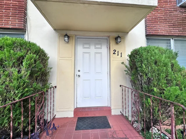 a view of a door and wooden floor