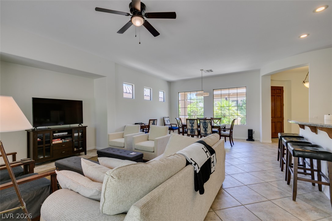 8 Kennesaw Road Henderson, NV 89052 - Photo 17 of 44 Natural light floods this living area, offering a fluid transition to the dining space.